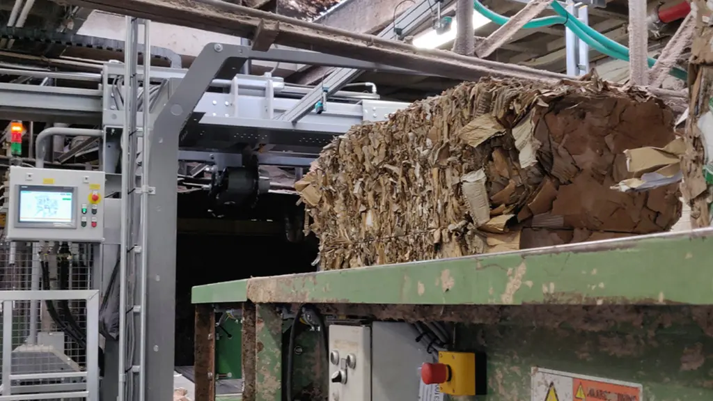 On image: Dewiring machine in stock preparation process, opening paper bales